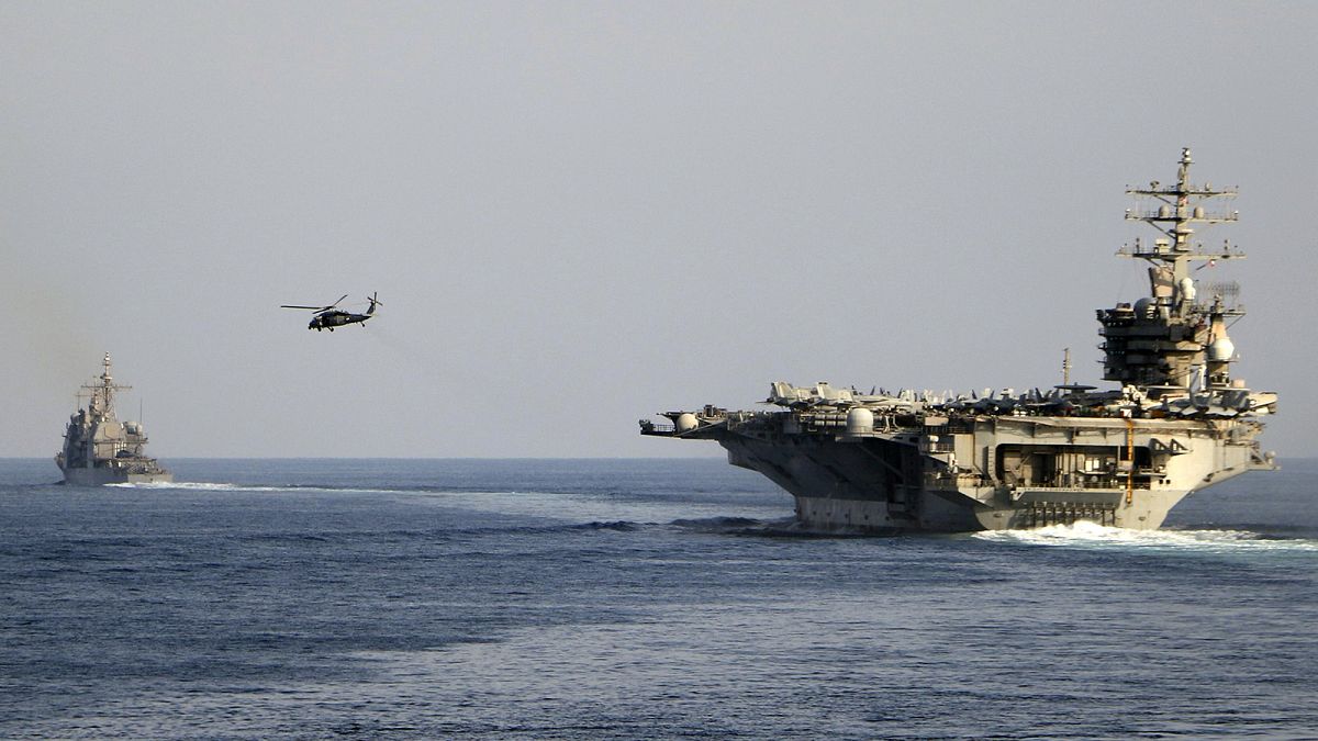 The aircraft carrier USS Dwight D. Eisenhower and other warships crosses the Strait of Hormuz into the Persian Gulf, 26 November 2023