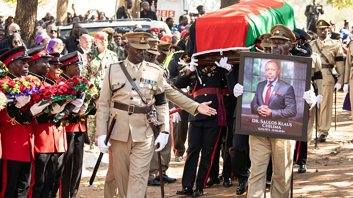 Pallbearers carry the coffin at the burial service for Malawi
