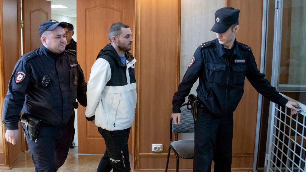 US Army Staff Sergeant Gordon Black is escorted into a glass cage at a courtroom in Vladivostok, Russia.