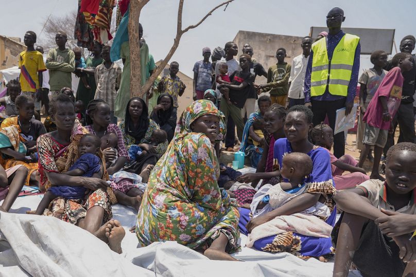 Des civils ayant fui le Soudan sont assis devant une clinique nutritionnelle dans un centre de transit à Renk, au Soudan du Sud, en mai 2023.