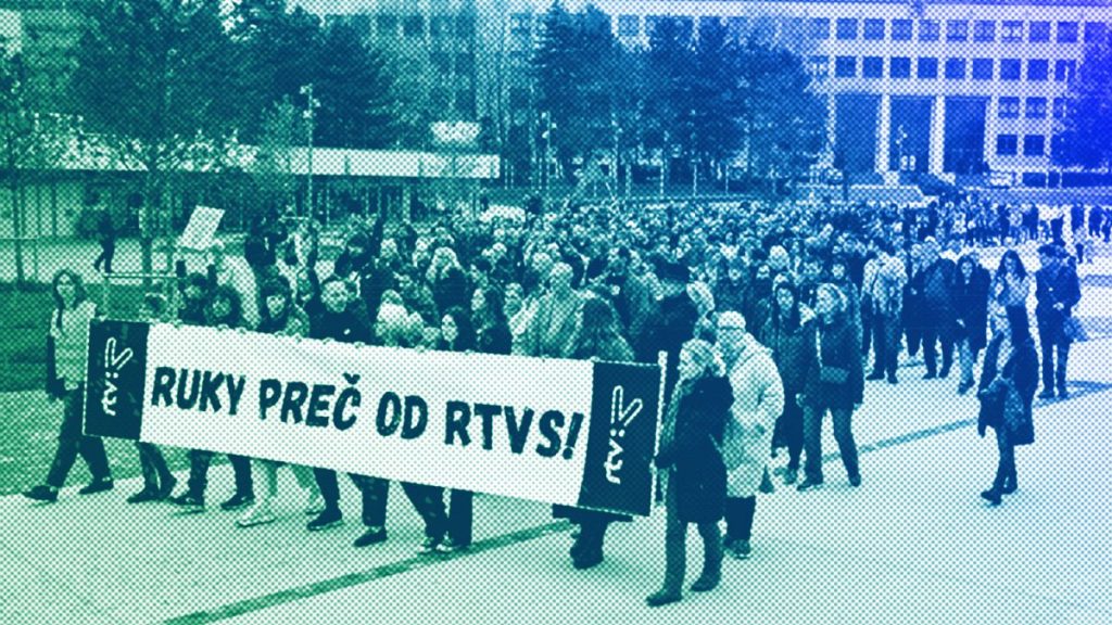 People hold a banner reading