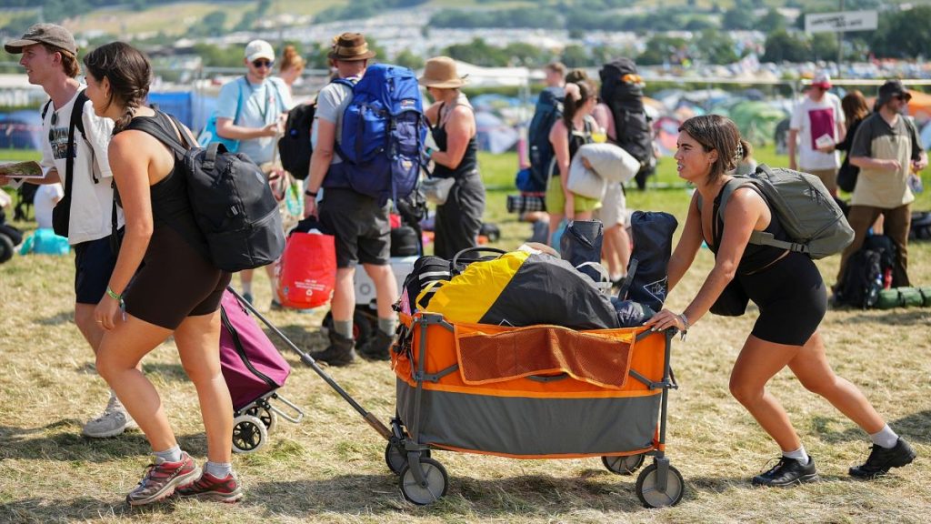 Festival goers arrive at the Glastonbury Festival in Worthy Farm, Somerset, England, Wednesday, June 26, 2024.