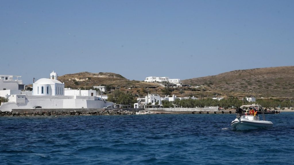 FILE- Medical staff in a dinghy leaves from the Aegean Sea island of Milos to Sikinos island, Greece, Monday, May 25, 2020.