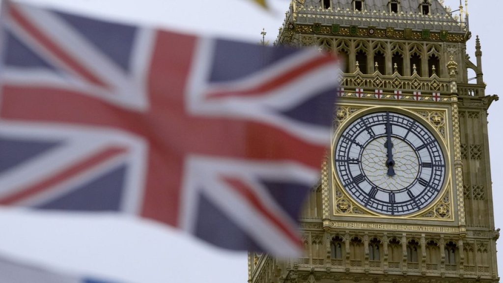 A British flag flies over a tourist kiosk on Westminster Bridge with the Elizabeth Tower, which contains the bell known as Big Ben, in the background, London, December 13 2023