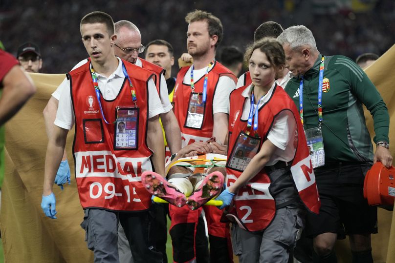 Barnabas Varga, de Hongrie, quitte le terrain sur une civière après avoir été blessé lors d'un match du groupe A entre l'Écosse et la Hongrie