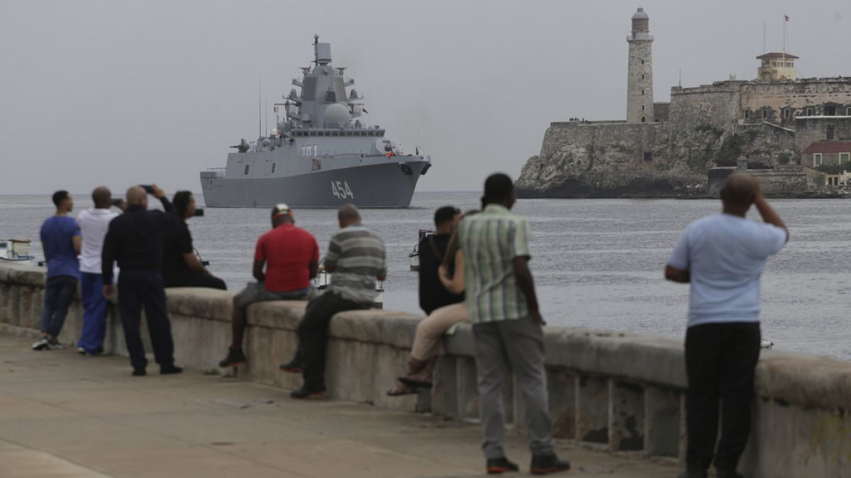 People watch the Russian Navy Admiral Gorshkov frigate arrive at the port of Havana, Cuba, Wednesday, June 12, 2024.