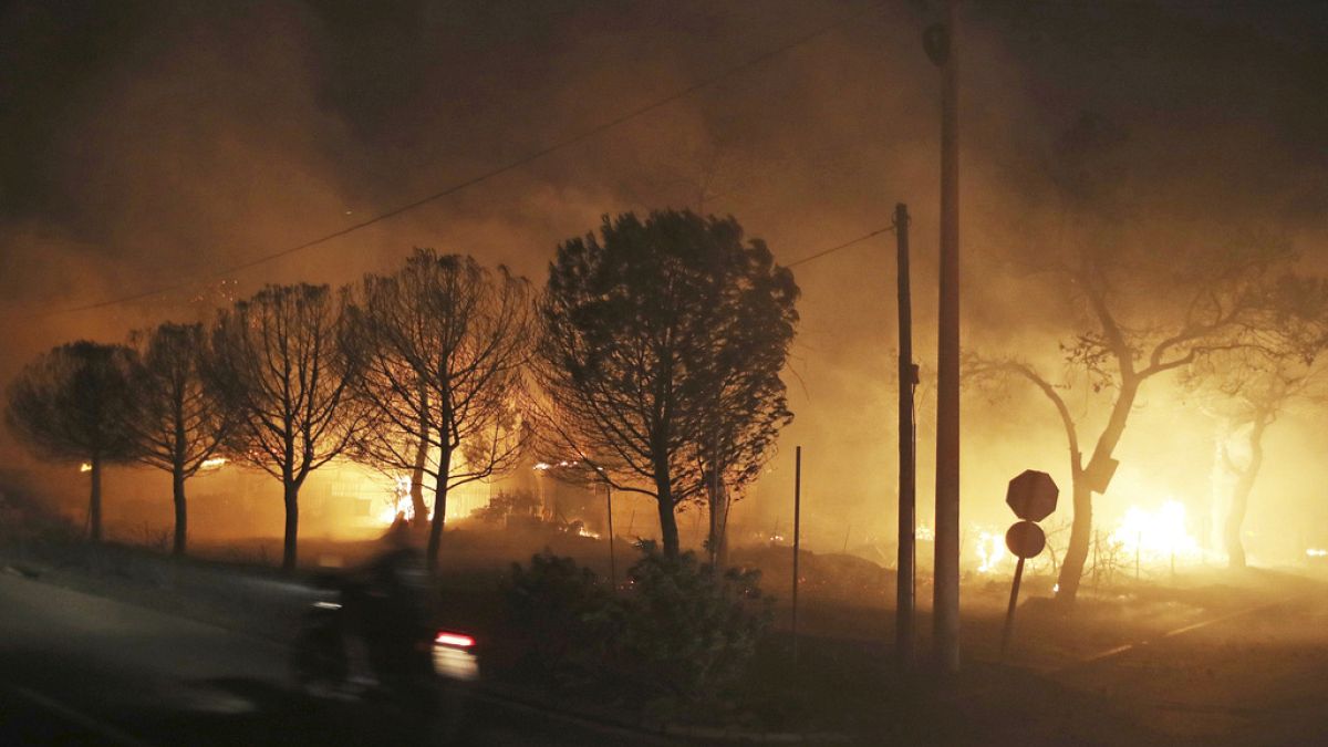 Buildings burn in the town of Mati, east of Athens, Greece, Monday, July 23, 2018.
