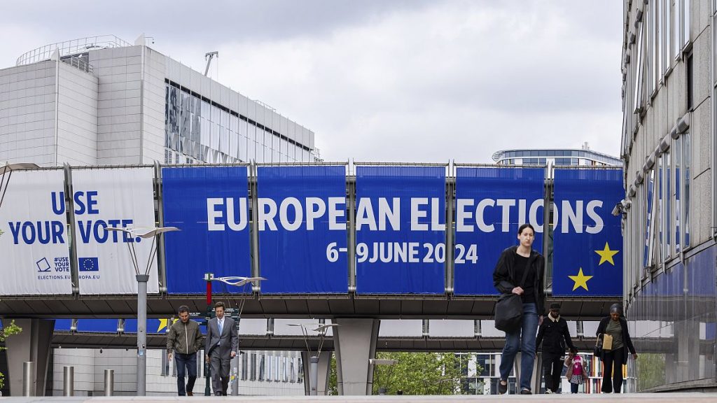 People walk outside the European Parliament prior to a debate with the lead candidates for the European Parliament elections in Brussels, Thursday, May 23, 2024.