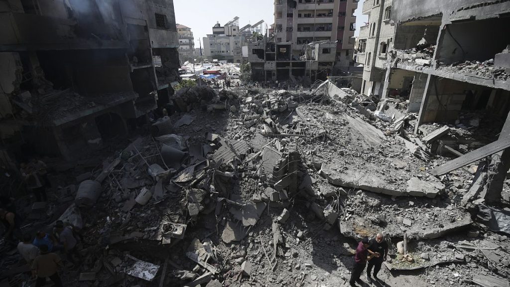 Palestinians look at the aftermath of the Israeli bombing in Nuseirat refugee camp, Gaza Strip, on June 8, 2024.