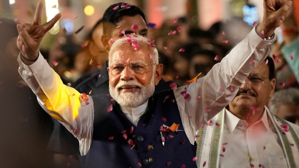 Prime Minister Narendra Modi greets supporters as he arrives at Bharatiya Janata Party (BJP) headquarters in New Delhi, India, Tuesday, June 4, 2024.