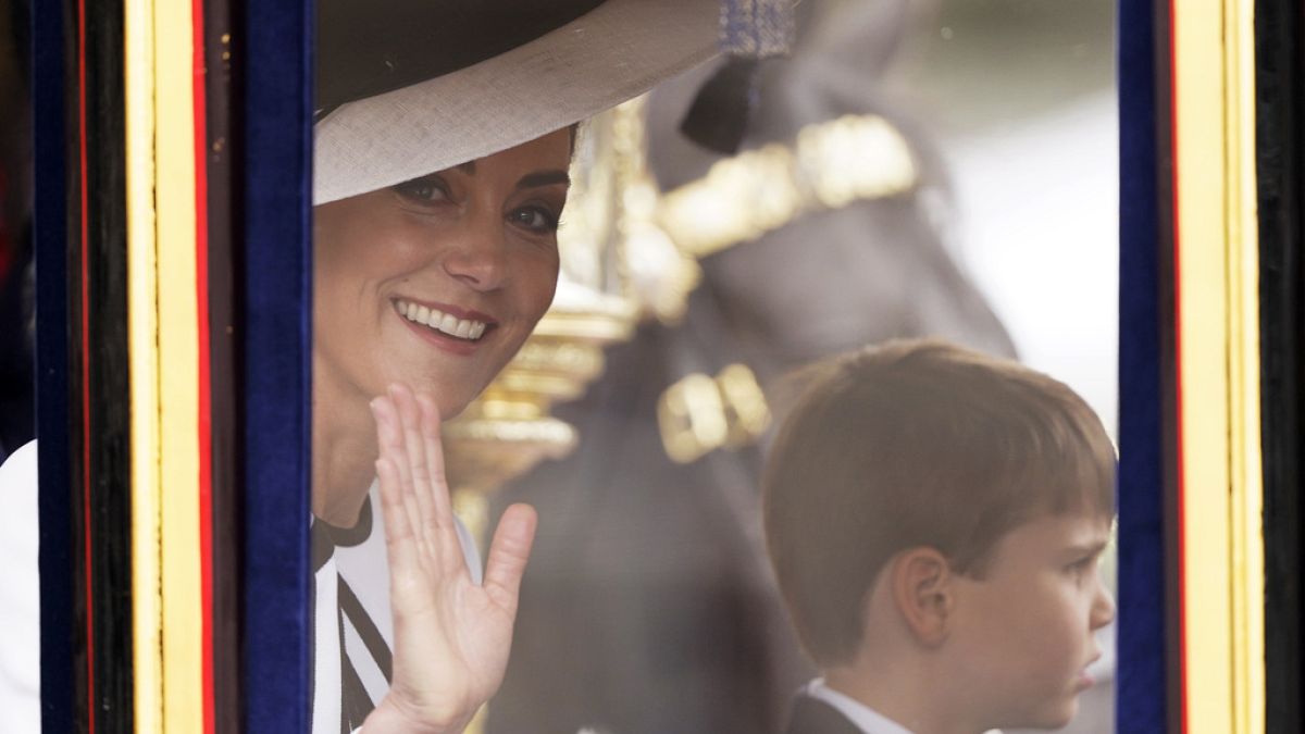 Kate, Princess of Wales waves to the crowd, with her youngest son Prince Louis of Wales alongside her in London, Saturday, June 15, 2024.