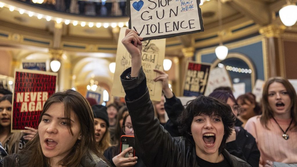 Students and supporters gather in the rotunda to protest gun violence during the opening day of the Iowa Legislature.