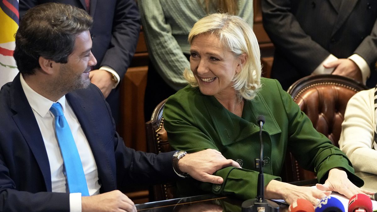 French far-right leader Marine Le Pen and Andre Ventura, leader of Portuguese party Chega, left, look at each other during a news conference at the Portuguese parliament