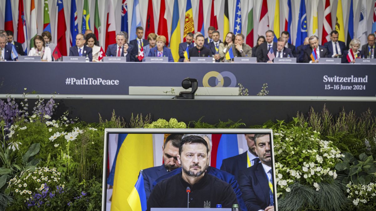 Ukrainian President Volodymyr Zelenskyy is seen on the screen during the plenary session during the Summit on peace in Ukraine, in Obbürgen, Switzerland, Sunday, June 16, 2024