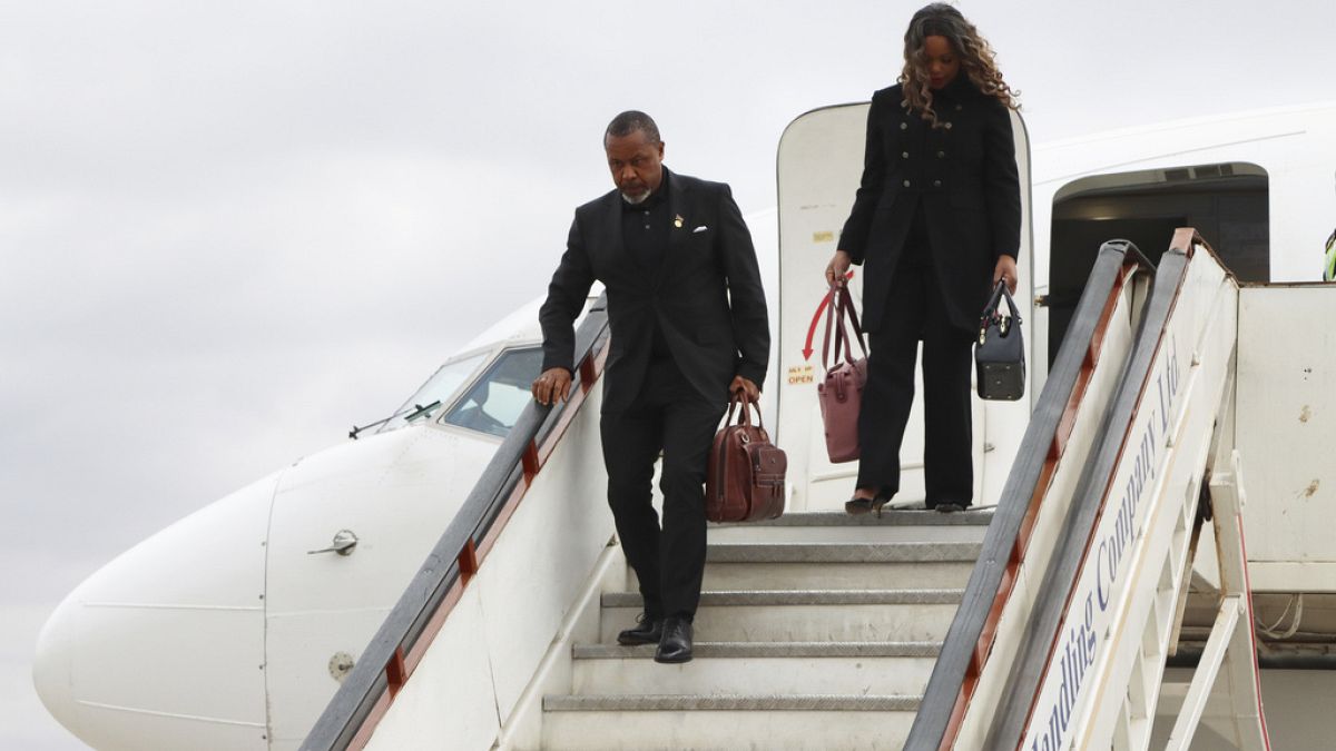 Malawi Vice President Saulos Chilima,left, and his wife Mary disembark from a plane upon his return from South Korea in Lillongwe, Sunday, June 9, 2024.