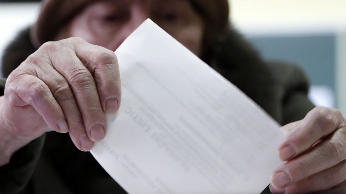 A voter casts her ballot at a polling station in Zagreb, 5 January 2020