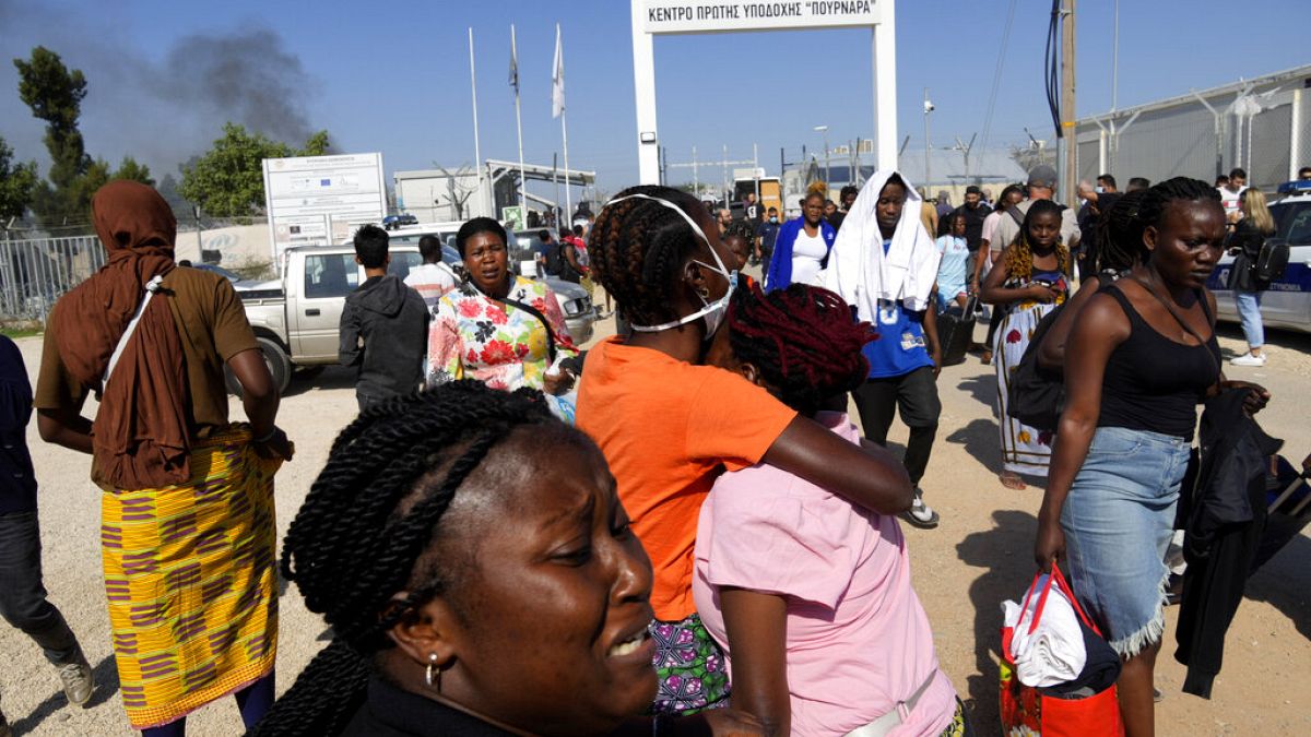 Female migrants exit the Pournara migrant reception center