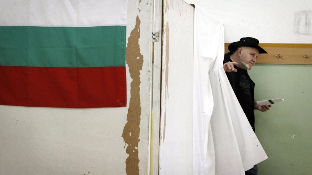 A Bulgarian walks out of a voting booth to cast his ballot for parliamentary elections in Sofia, Sunday, May 12, 2013 (AP Photo/Valentina Petrova)