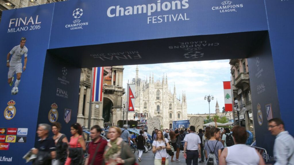 People walk by the Uefa Champions League fans zone near the Duomo gothic cathedral, in Milan, Italy, on May 25, 2016.