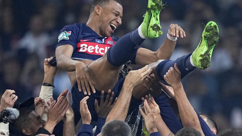 Kylian Mbappe is tossed into the air after the French Cup final soccer match between Lyon and PSG at the Pierre Mauroy stadium, northern France, Saturday, May 25, 2024.