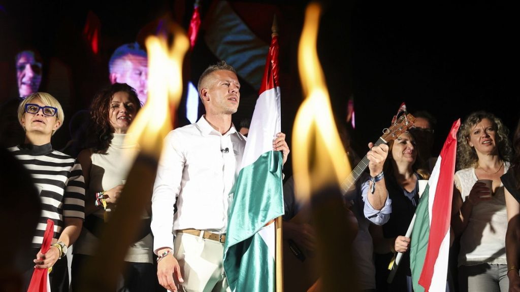 Peter Magyar sings with his supporters during the party