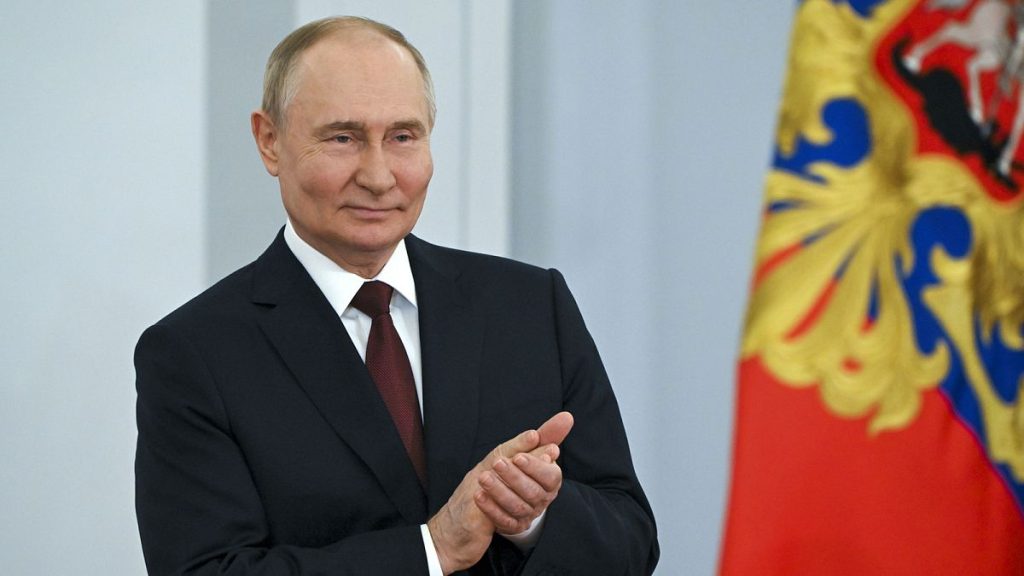 Russian President Vladimir Putin applauds at a ceremony during the celebration the Day of Russia at the Kremlin, 12 June 2024