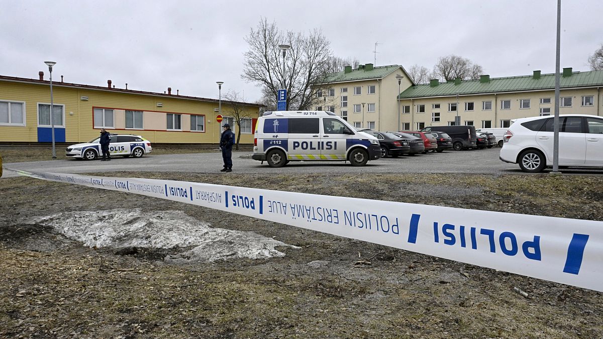 FILE - Police officers stand guard outside Viertola comprehensive school, in Vantaa, Finland, Tuesday, April 2, 2024.