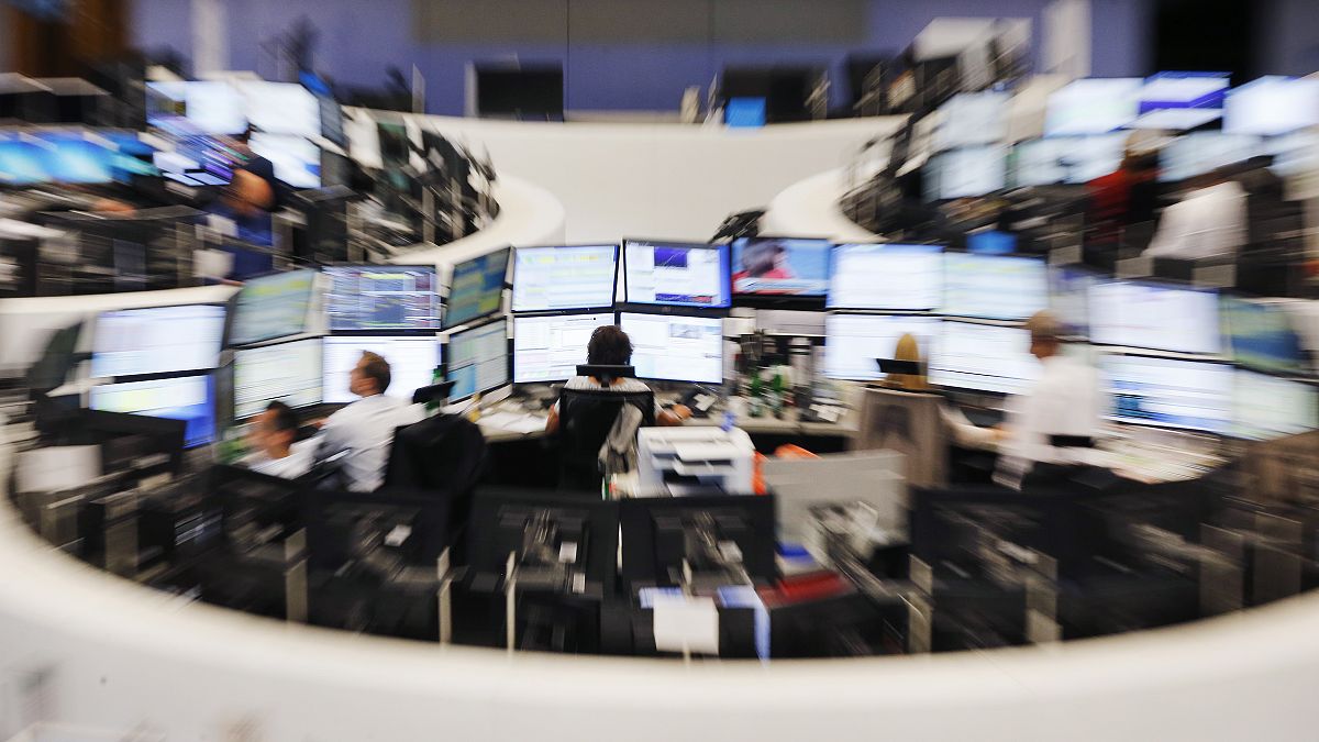 Traders sit in front of their screens at the stock market in Frankfurt, Germany (file photo)