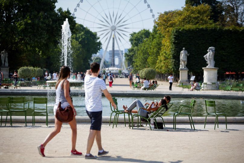 Les gens se promènent dans les emblématiques jardins des Tuileries à Paris