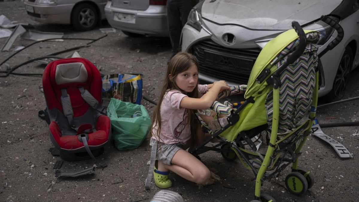 Polina, 10, looks after her sister Marina, 3, at the site of Okhmatdyt children