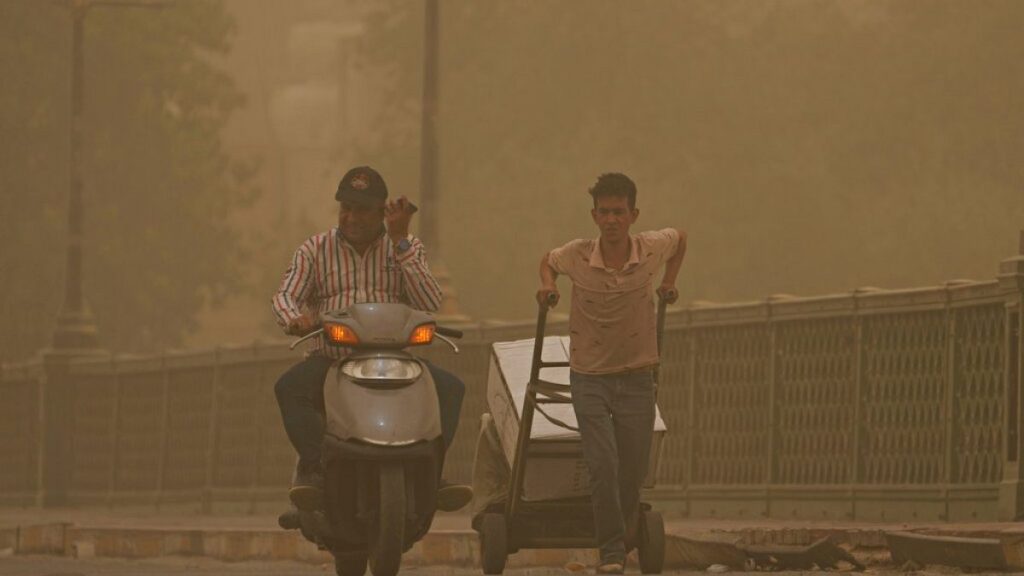 In the eye of the storm: People walk on a bridge during a sandstorm in Baghdad, Iraq in 2022