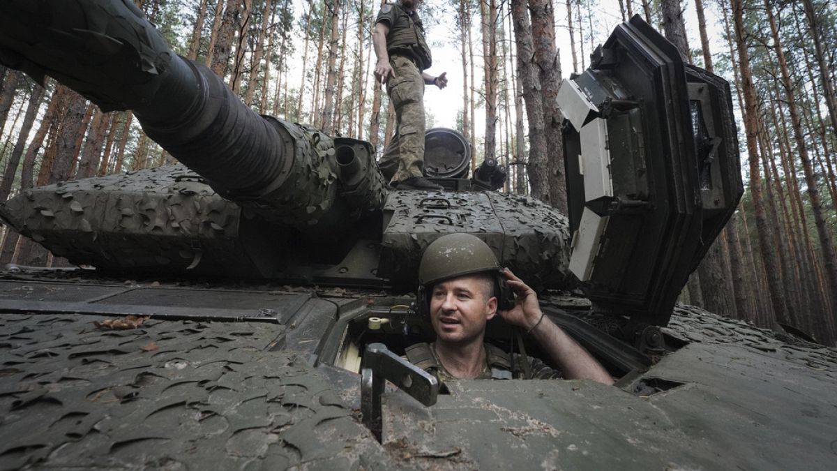 A Ukrainian soldier from 57th brigade looks out from a Swedish Combat Vehicle 90 near front line in Kharkiv region, Ukraine, Tuesday, June 18, 2024. (AP Photo/Andrii Marienko)