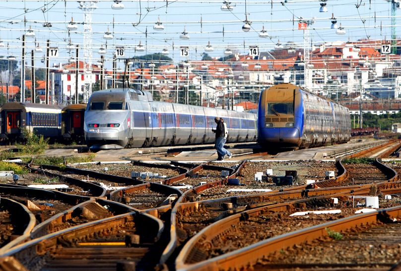 Des cheminots traversent les voies ferrées à la gare d'Hendaye, dans le sud-ouest de la France, en novembre 2008