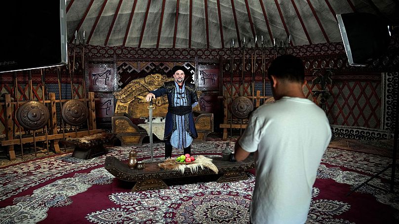 Un touriste porte une coutume ottomane pour une photographie, lors de sa visite au studio de cinéma en plein air de Bozdag à Istanbul, en Turquie, le 12 juin 2024. 