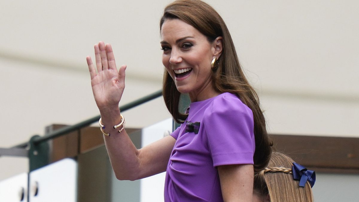 Kate, Princess of Wales waves as she makes her way to Center Court ahead of the men