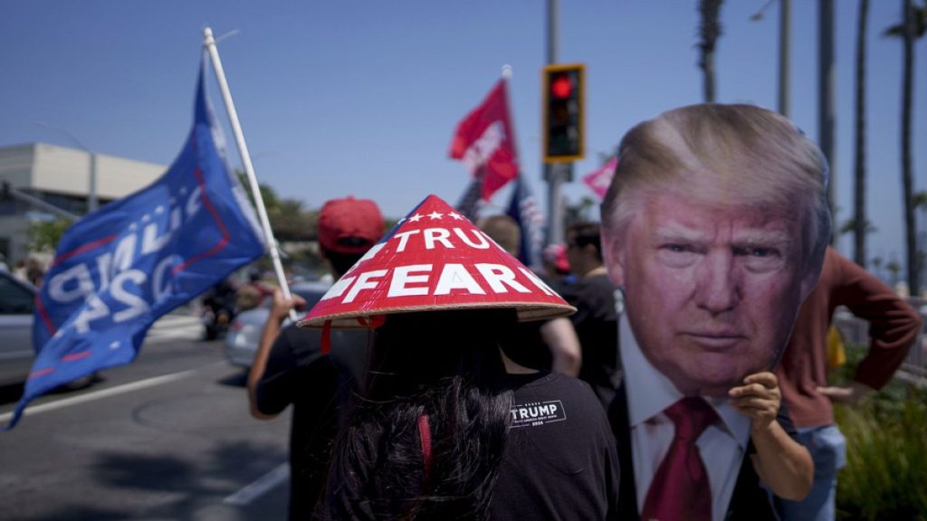 People rally in support of Republican presidential candidate former President Donald Trump in Huntington Beach, Calif., Sunday, July 14, 2024. (AP Photo/Eric Thayer)