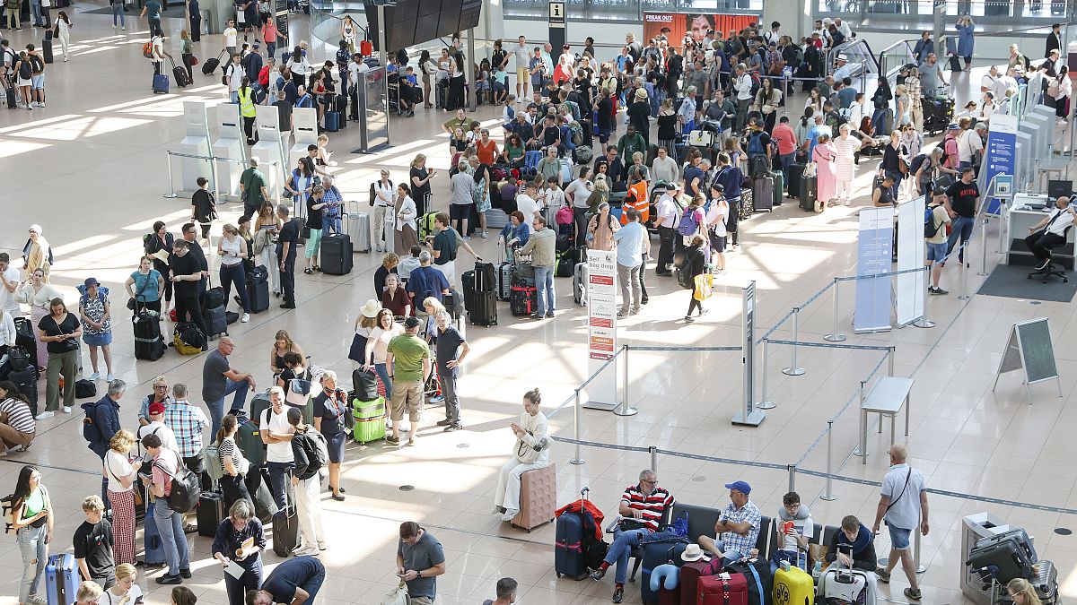 Travelers wait in Terminal 1 for check-in at Hamburg Airport, July 19, 2024