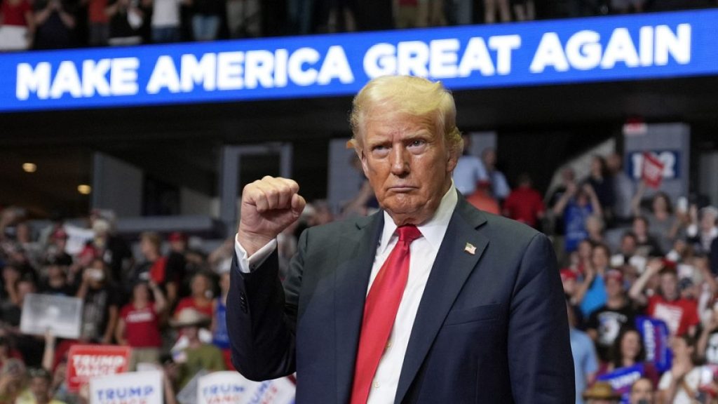 Republican presidential candidate former President Donald Trump reacts after speaking at a campaign rally on Saturday in Michigan