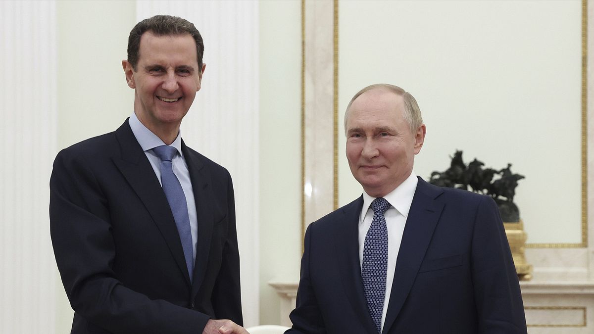 Syrian President Bashar Assad and Russian President Vladimir Putin shake hands during their meeting in Moscow, Russia, Wednesday, July 24, 2024.