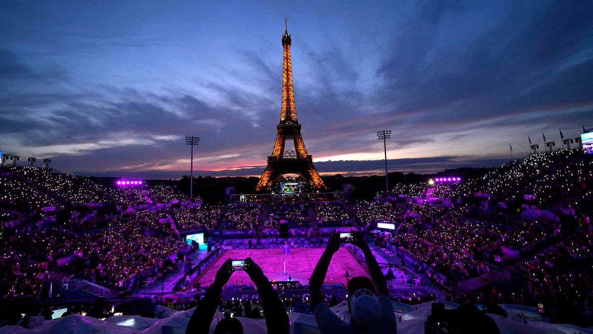 The Eiffel Tower takes centre stage at a beach volleyball match at the 2024 Summer Olympics, Saturday, July 27, 2024, in Paris, France.