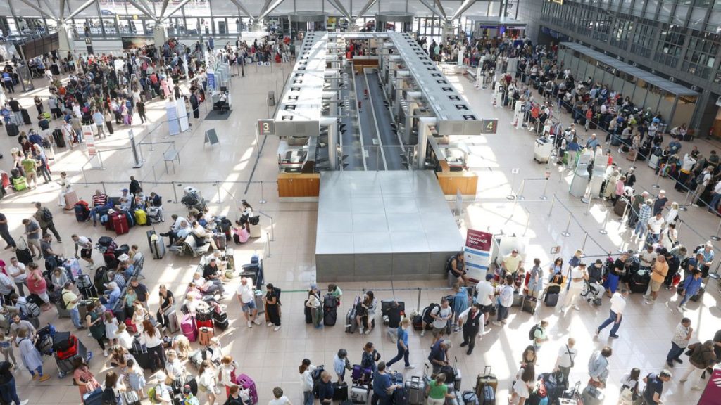 Travelers wait in Terminal 1 for check-in at Hamburg Airport, in Hamburg, Germany, Friday July 19, 2024.