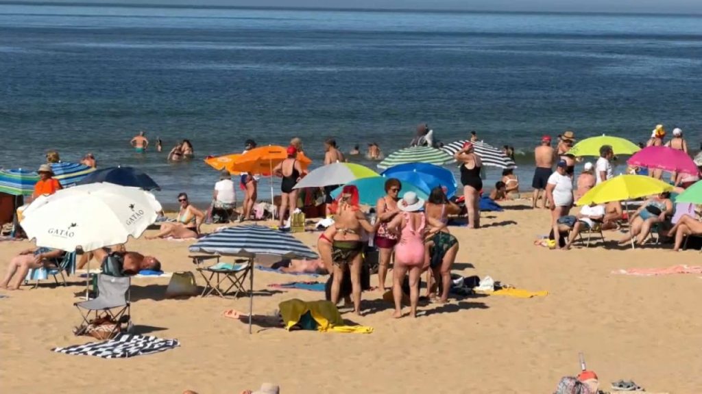 Portuguese citizens flock to the beach in Lisbon during heatwave.