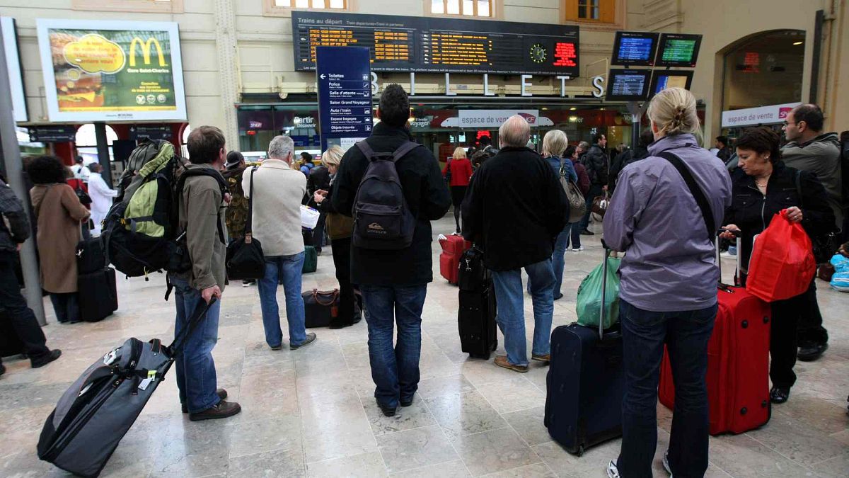 People wait on the platform to take a high-speed train at the Saint-Charles railway station in Marseille, southern France, Tuesday,Oct. 20, 2009.