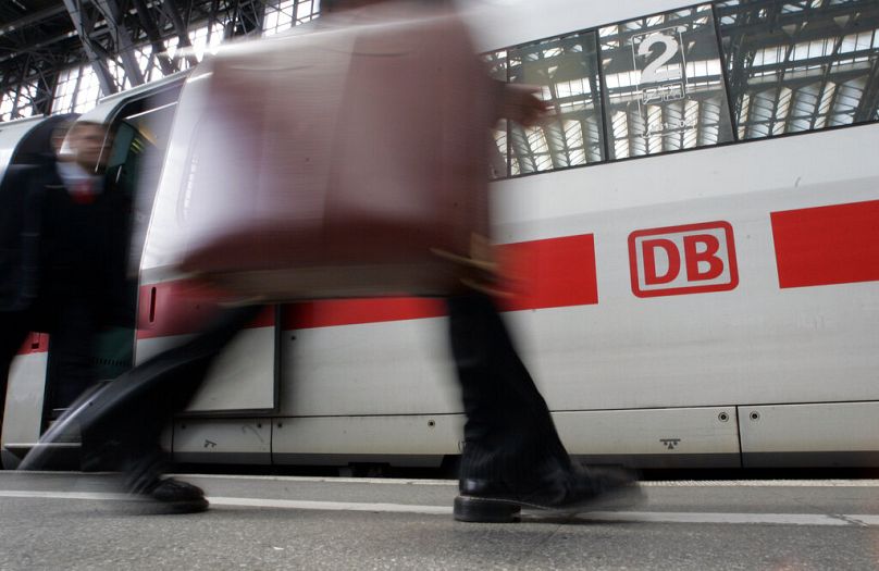 Un passager passe devant un train express ICE à Cologne, en avril 2008