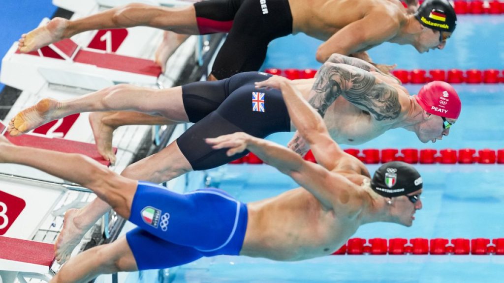 Adam Peaty, of Britain, competes during a heat in the men