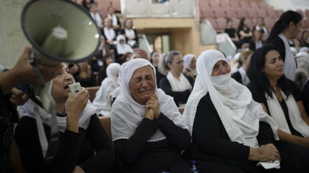 Members of the Druze minority attend a memorial ceremony for the children and teens, killed in a rocket strike in the village of Majdal Shams (AP Photo/Leo Correa)