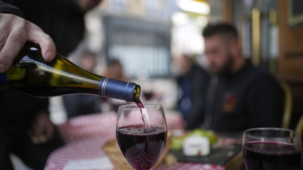 French delight: A customer pours a glass of Beaujolais Nouveau wine in a restaurant of Boulogne Billancourt, outside Paris