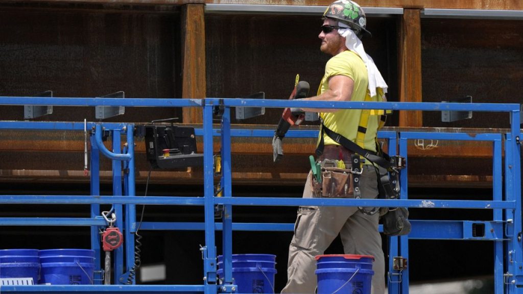 A worker uses a towel for protection from the sun