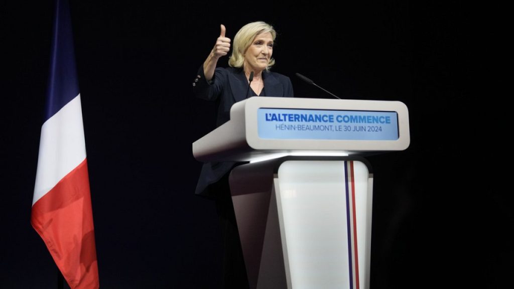 French far right leader Marine Le Pen thumbs up as she delivers her speech after the release of projections based on the actual vote count in select constituencies , Sunday