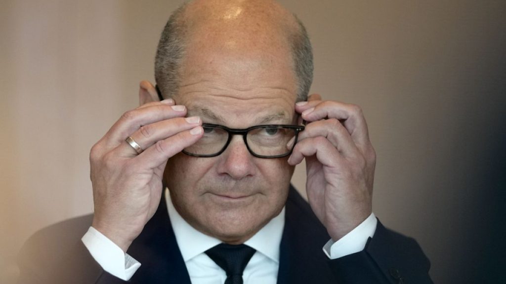 Chancellor Olaf Scholz adjusts his glasses as he arrives for the cabinet meeting in the Chancellery in Berlin, Germany, Wednesday, June 19, 2024